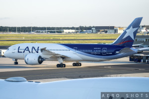 a blue and white airplane on a runway